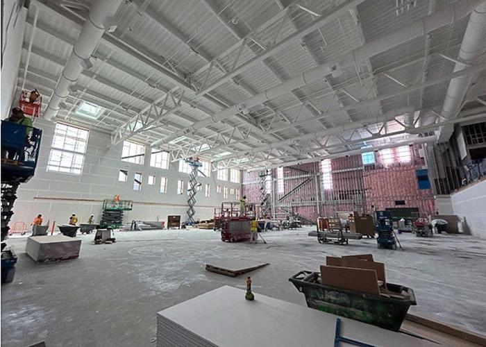 inside of a large room under construction with construction materials and equipment